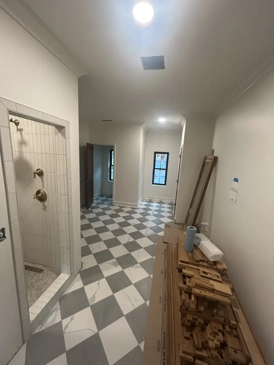 Hallway with checkerboard tile inside the addition