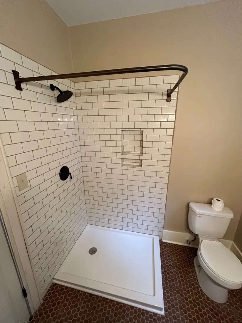 Finished walk-in shower with white subway tile