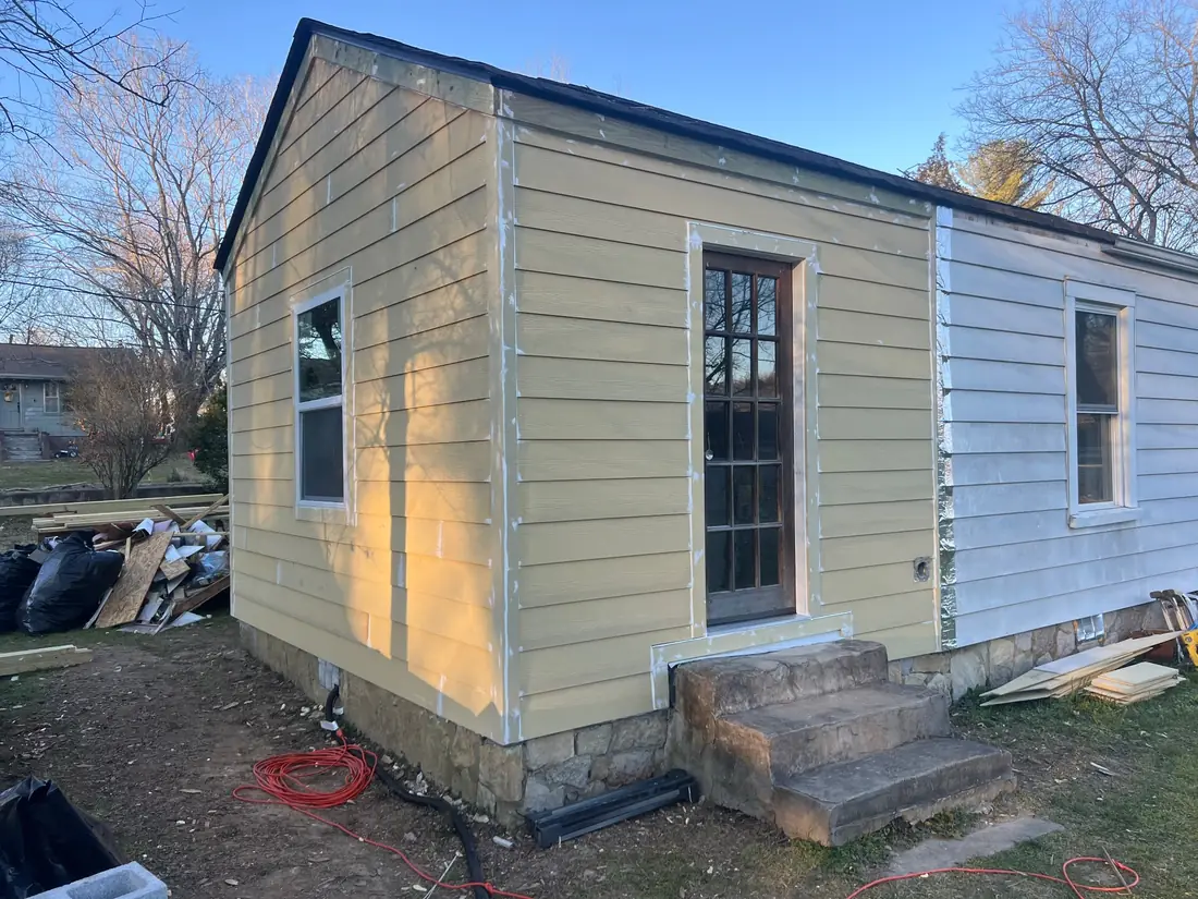 Completed outbuilding with new siding and trim