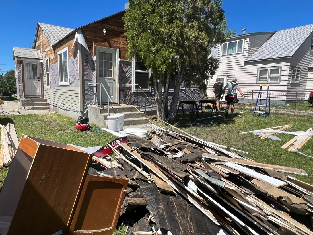 Home before exterior renovation, during tear-off
