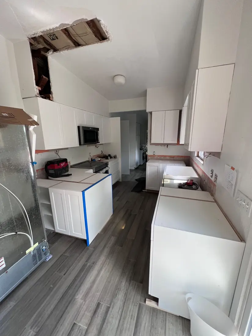 Same kitchen in progress, cabinets being installed