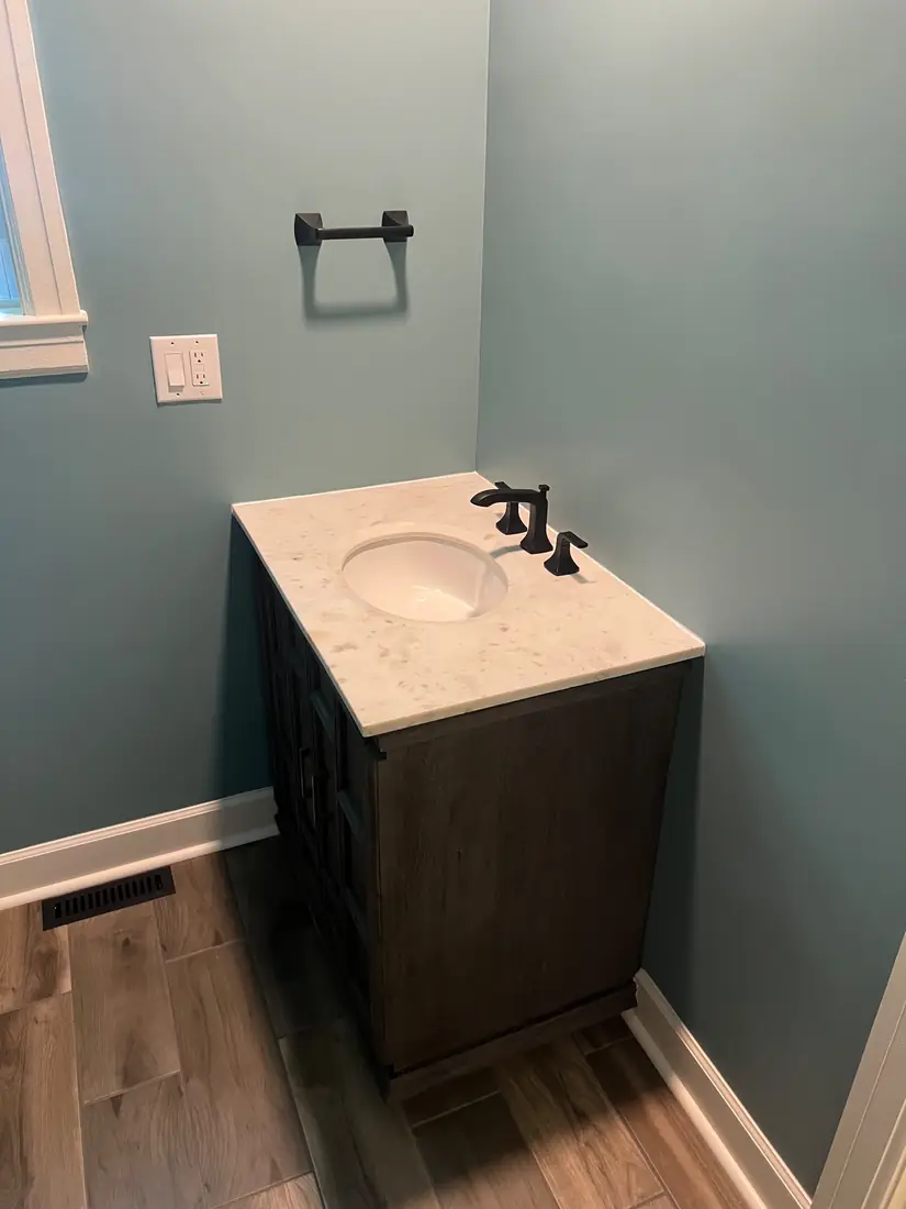 Bathroom vanity with marble top and matte black fixtures
