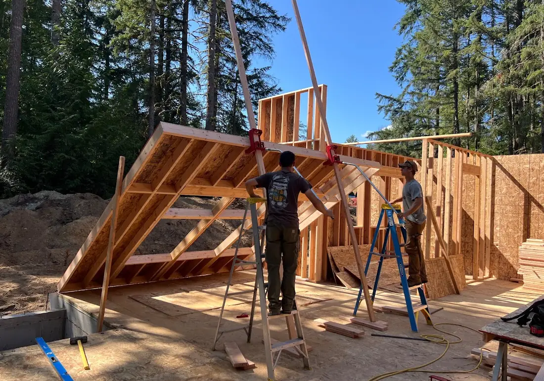 New home under construction with wall framing being raised