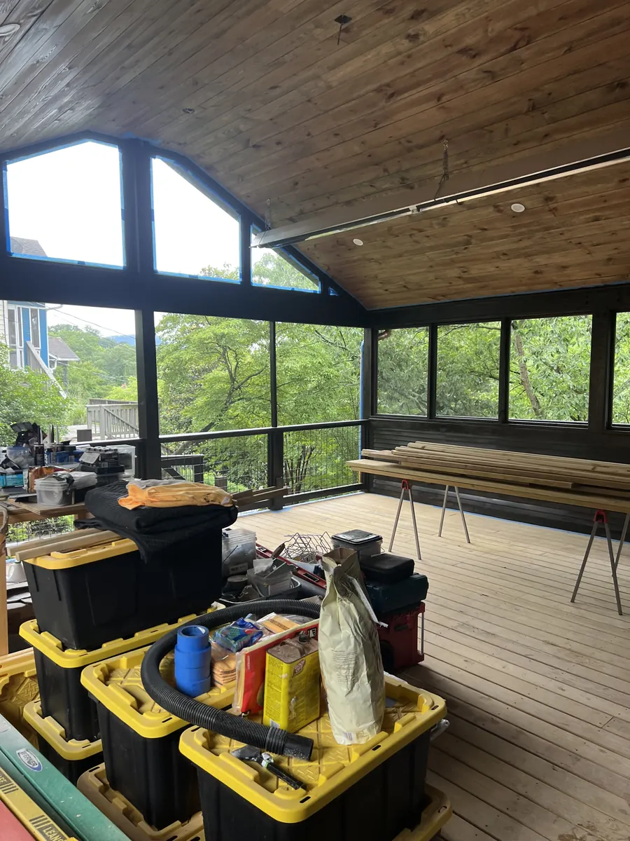 Finished screened porch with cedar ceiling and hillside view