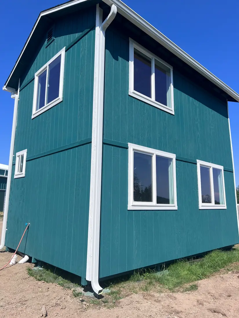 Completed tiny home build with board-and-batten siding